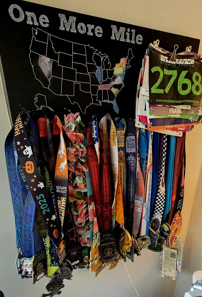 Frank Mesa's endurance medals and race bibs earned through years of consistent training